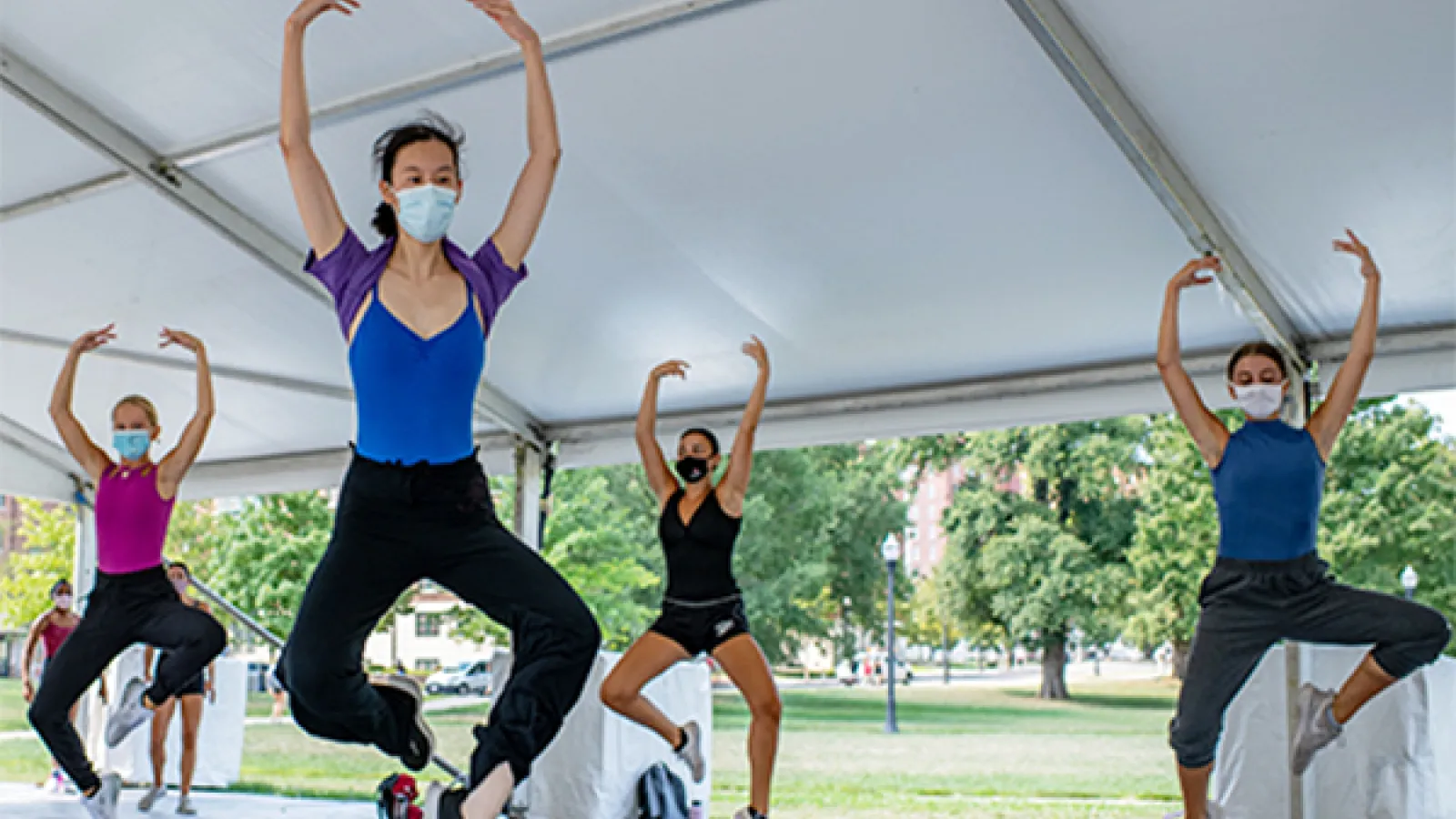 Dancers practice movement in one of the arts tents