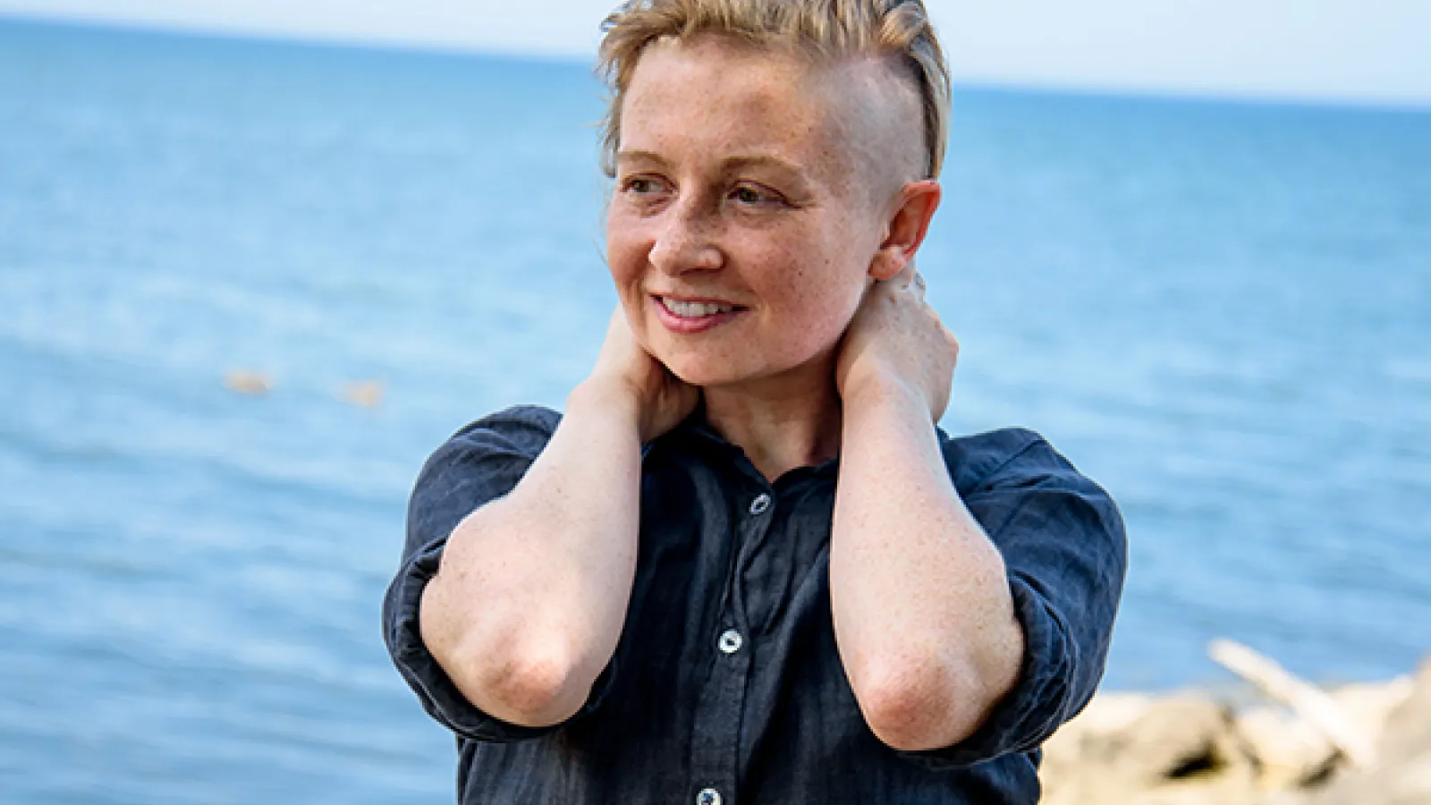 person standing in front of a body of water