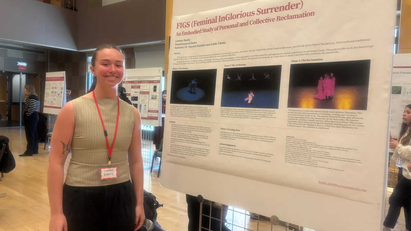 Woman standing next to a poster